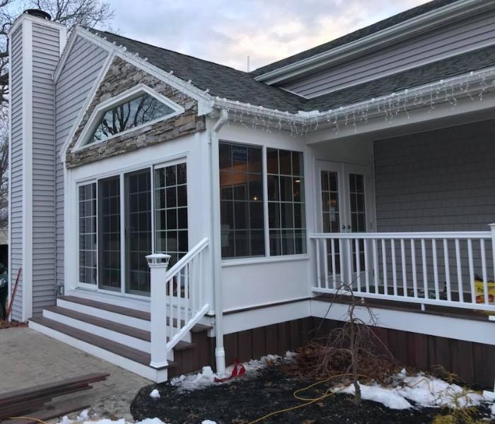 home with white wrap around porch - new exterior siding