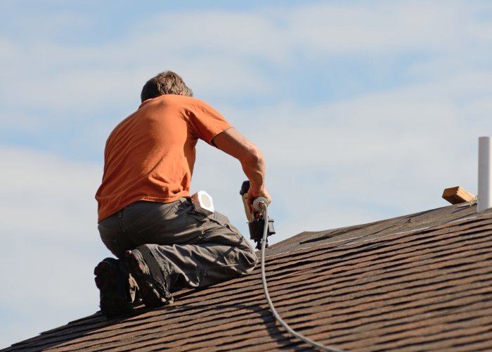 roofer working on tile roof at RI home